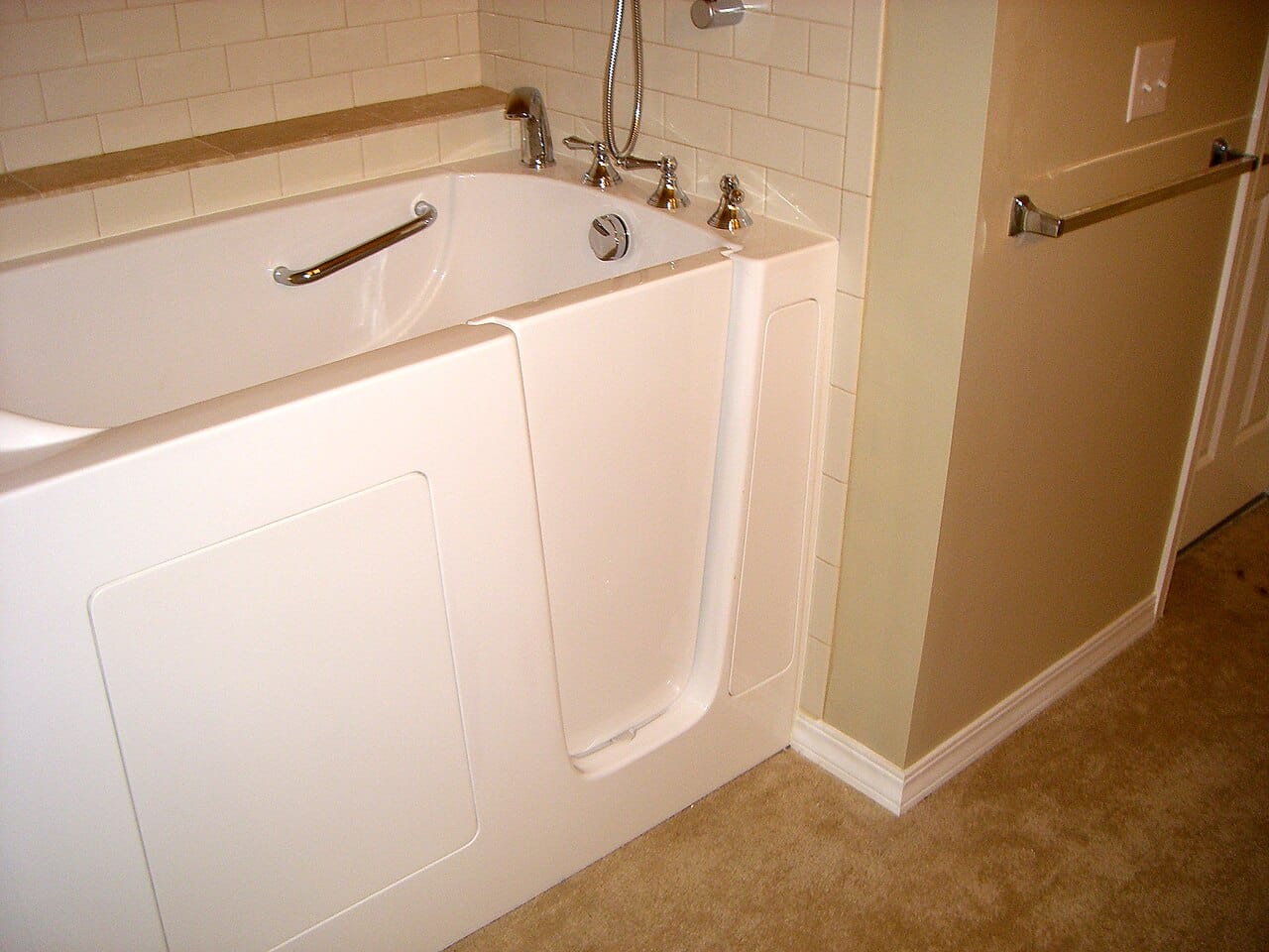 A walk-in bath with a side door and built-in seat