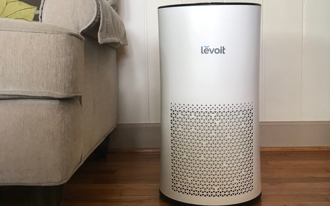 A white HEPA air purifier standing on the floor in a home