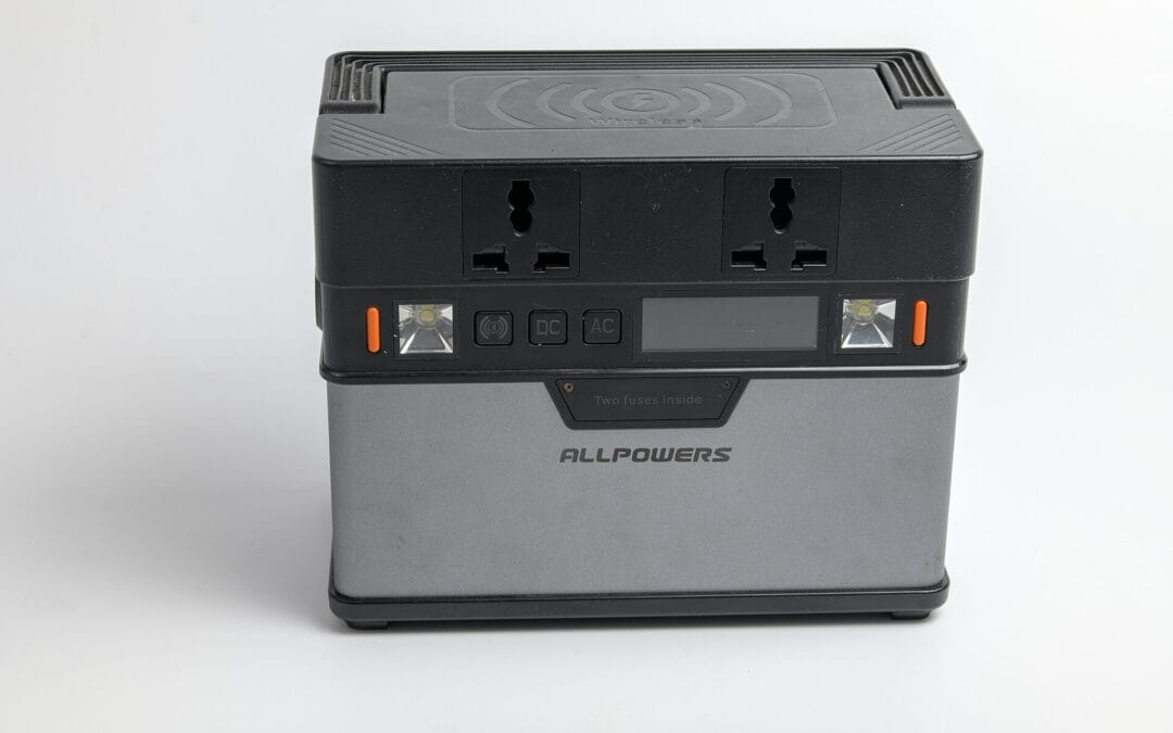 A portable power station with AC and DC outputs and a solar charge controller, used for camping and festival power