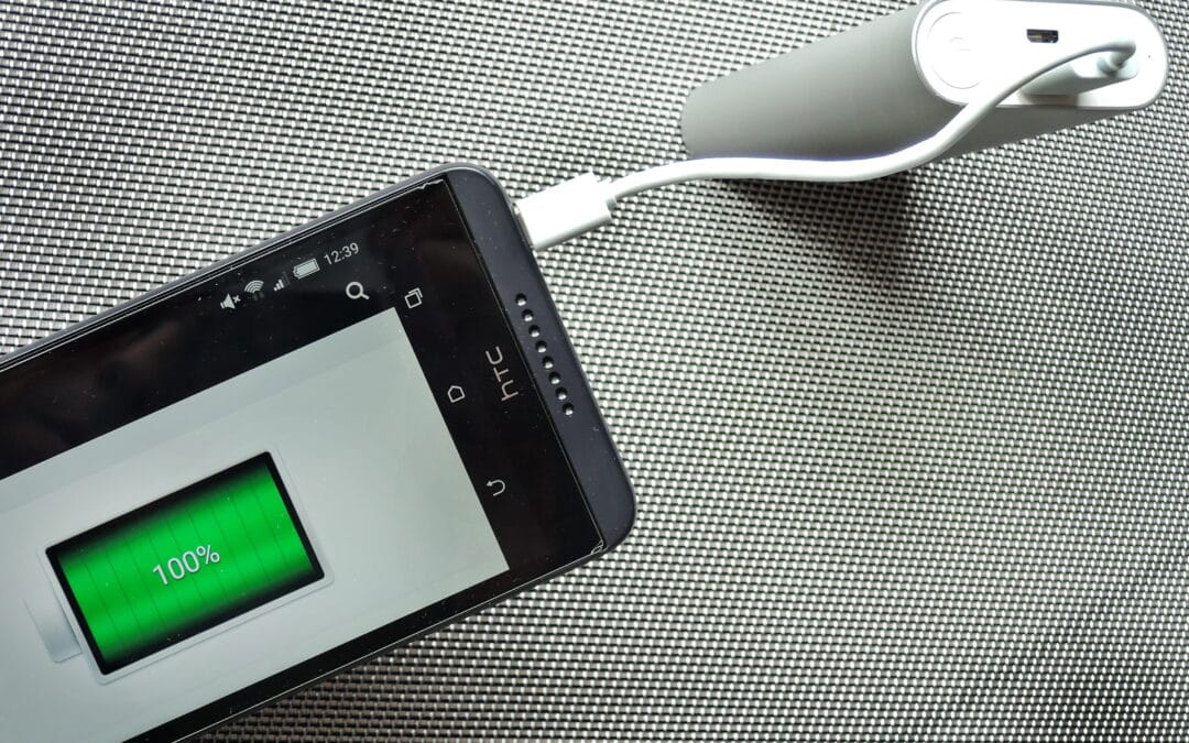 A smartphone being charged from a USB power bank