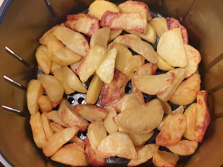 Roast potato wedges in an air fryer basket