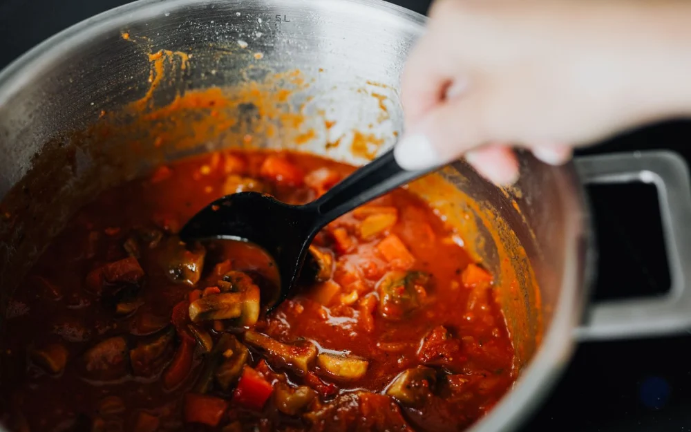 Close-up of chilli con carne cooking in a white slow cooker pot