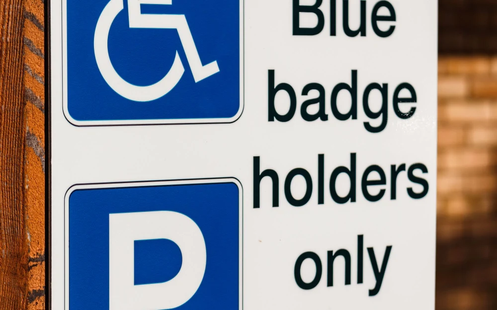 Sign reading Blue badge holders only, with wheelchair and parking symbols