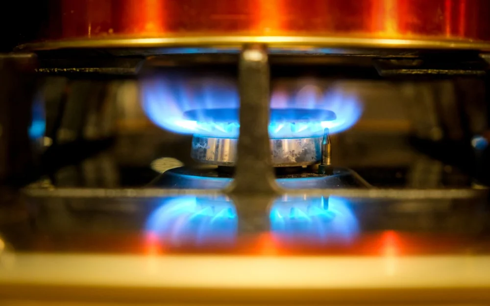 Blue flame burning on a gas hob ring