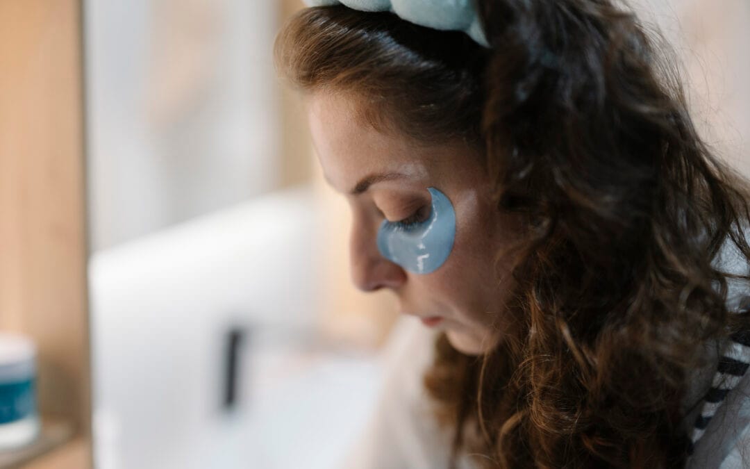 Close-up of a woman applying skincare product to her face