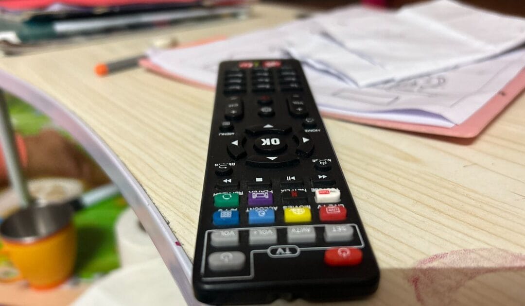 A TV remote control resting on a table