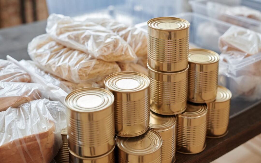 Stack of tinned and packaged food on a table