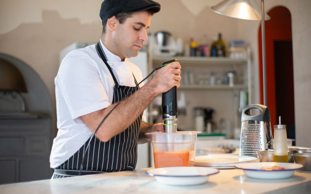 Chef blending ingredients in a kitchen