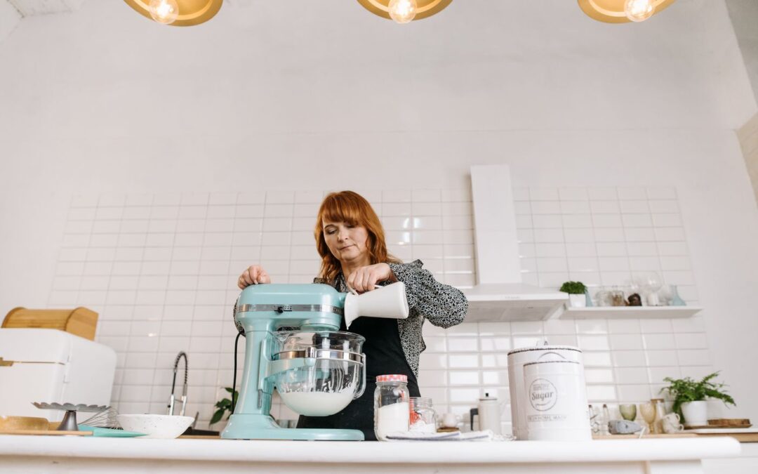 Pouring milk into a stand mixer while baking