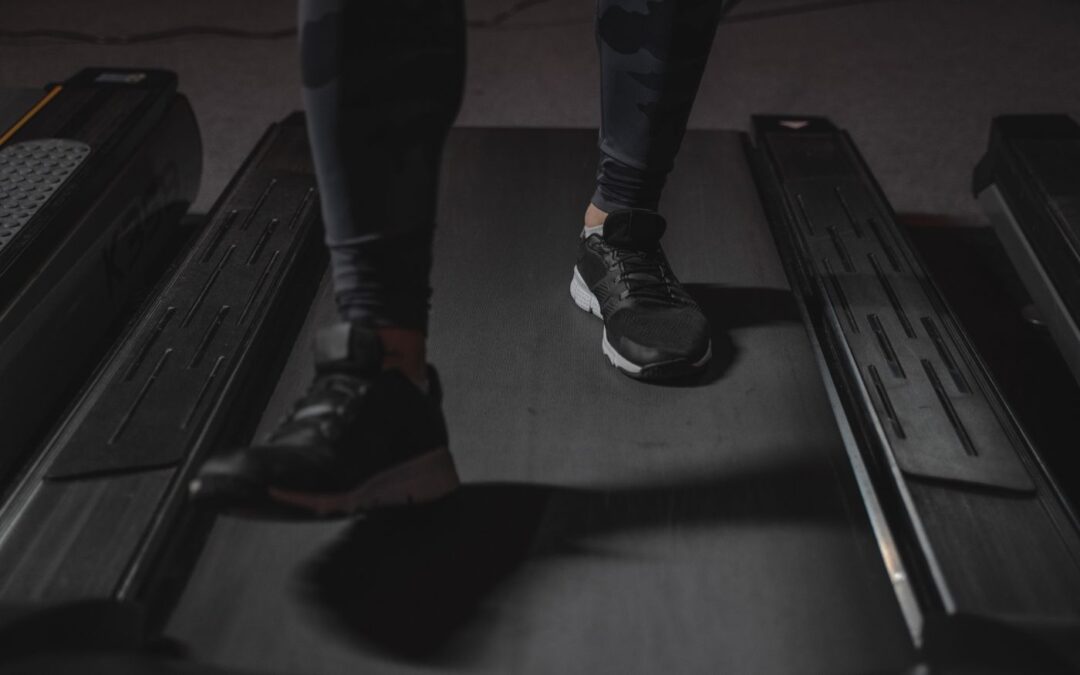 Feet mid-stride on a treadmill belt