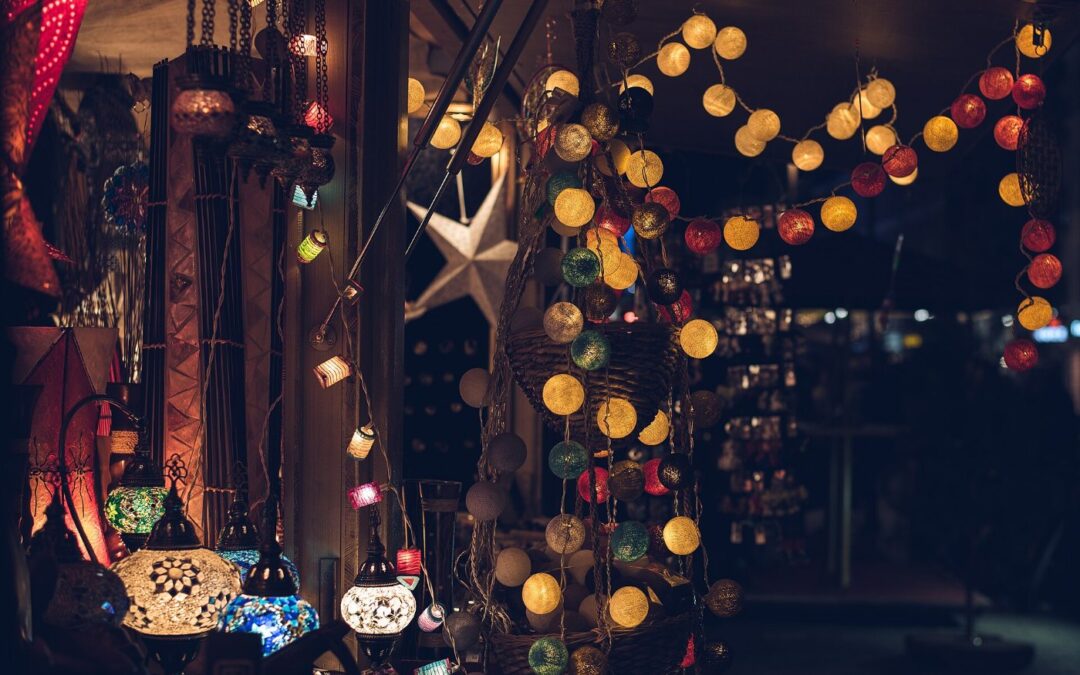 Strings of warm white and coloured Christmas lights hanging in a dark room