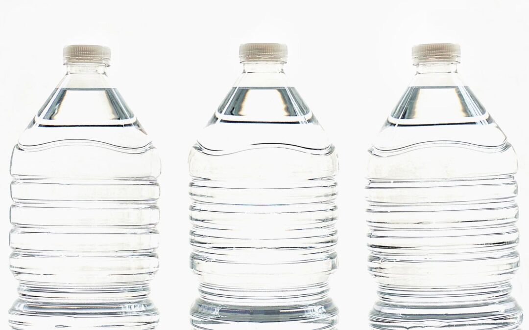 Three clear plastic bottles of water